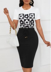 zweiteiliges schwarzes figurbetontes Oberteil und Rock mit Blumendruck