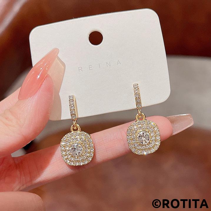 Boucles d'oreilles circulaires brillantes en or avec strass